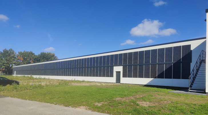 In zwei Reihen übereinander haben die Solarteure die Leichtbaumodule an die Wand des Gebäudes der Group 24 geklebt.