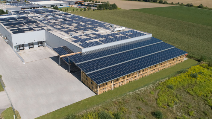Das solar eingedeckte Flugdach kragt an der südwestlich ausgerichteten Fassade der Modulproduktion von Kioto Solar heraus.
