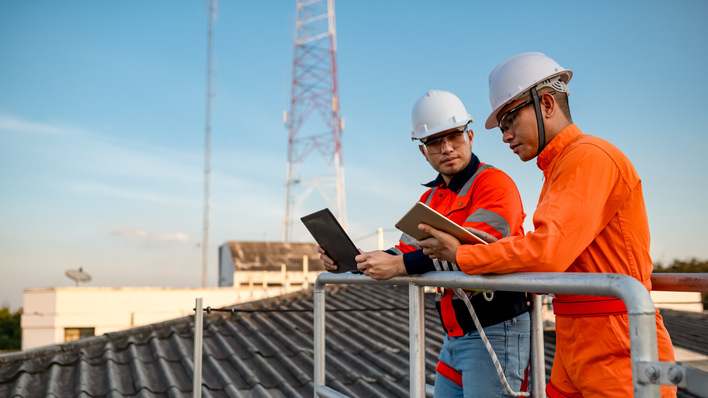 Two engineers are planning to install solar cells on the roof of a building.